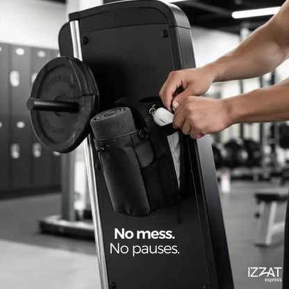 Person at a gym machine with the Tazzi IronGrip Gym Vault bag placed nearby — lifestyle gym scene showing the bag in its natural environment alongside workout equipment